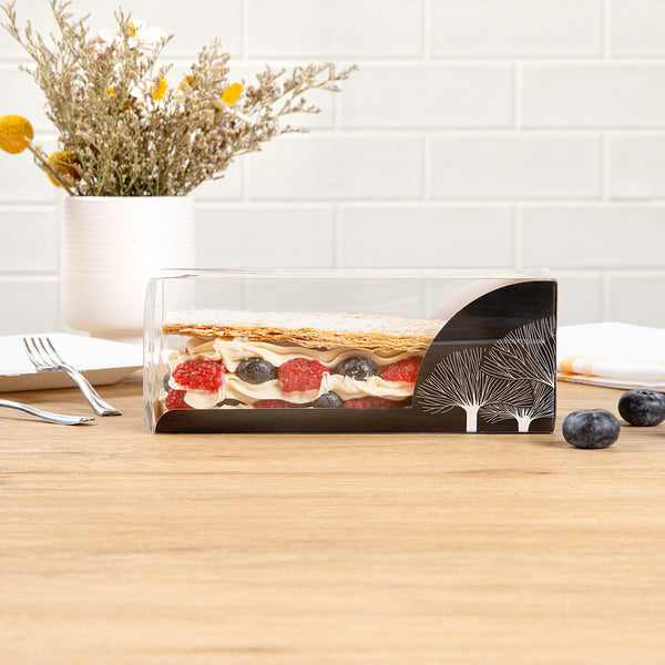 Restaurantware Sweet Vision Rectangle Clear Plastic Eclair Box - Black Paper Sleeve Tree Accent - 7" X 2 1/2" X 2 1/2" - 100 Count Box