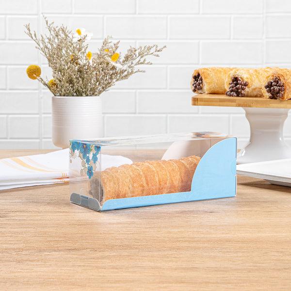Restaurantware Sweet Vision Rectangle Clear Plastic Eclair Box - Blue Paper Sleeve Flower Accent - 7" X 2 1/2" X 2 1/2" - 100 Count Box