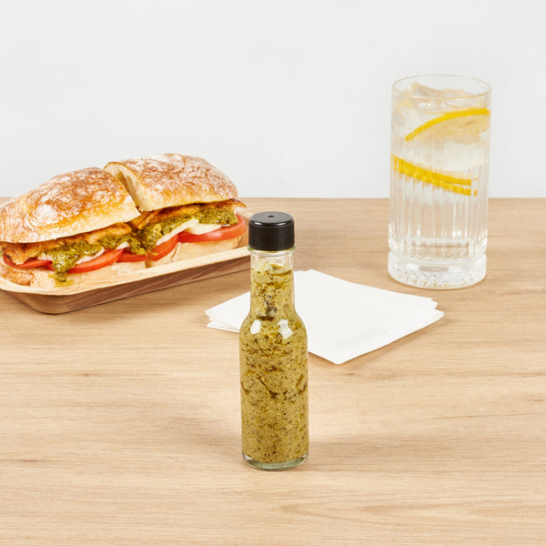 Restaurantware Vetri 3 Oz Glass Woozy Bottle - With Black Cap - 1 1/2" X 1 1/2" X 6" - 10 Count Box
