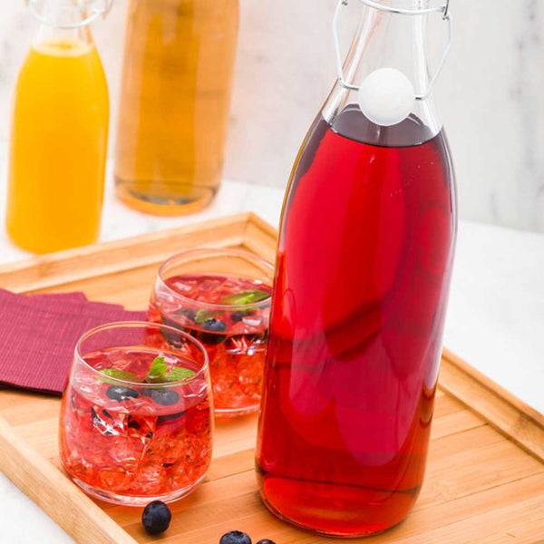 Restaurantware Vetri 34 Oz Round Glass Nostalgic Bottle - Swing Top - 3 1/4" X 3 1/4" X 12 1/2" - 10 Count Box