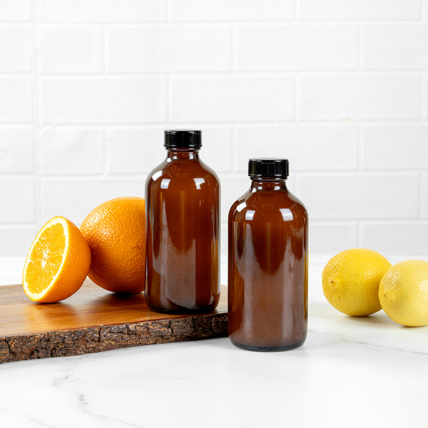 Restaurantware Vetri 8 Oz Boston Round Amber Glass Bottle - With Black Phenolic Cap - 2 1/2" X 2 1/2" X 5 1/2" - 12 Count Box