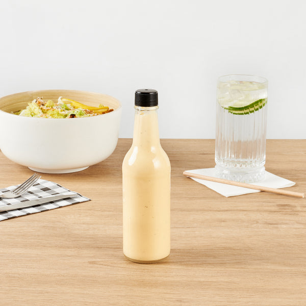 Restaurantware Vetri 9 Oz Glass Woozy Bottle - With Black Cap - 2 1/4" X 2 1/4" X 7 3/4" - 10 Count Box