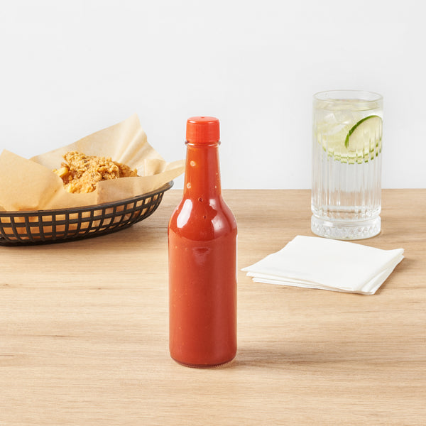 Restaurantware Vetri 9 Oz Glass Woozy Bottle - With Red Cap - 2 1/4" X 2 1/4" X 7 3/4" - 10 Count Box