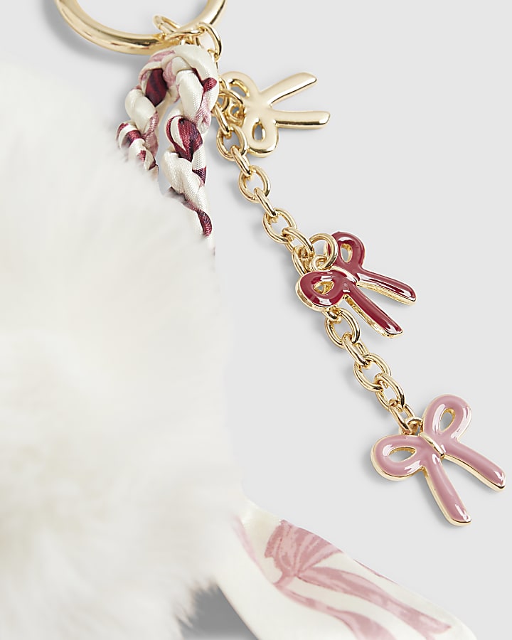 River Island Cream Plaited Scarf Pom Pom Bow Bag Charm