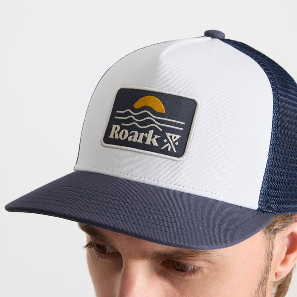 Roark Station Trucker Snapback Hat In White/Navy