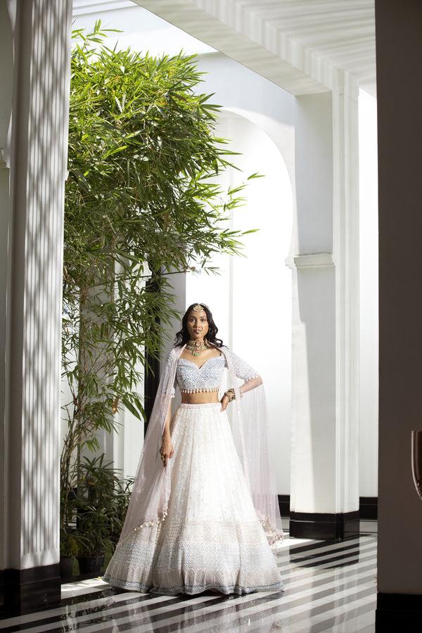 roqa MIA Off-white lehenga set with contrasts of pink & turquoise