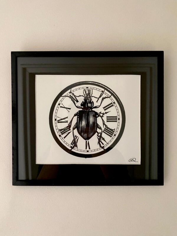 rory dobner Framed Beetle Clock Print