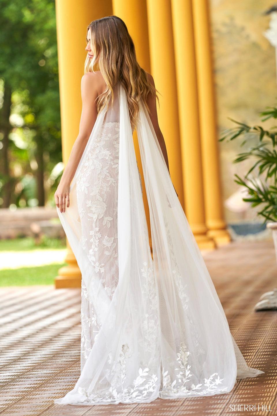 Sherri Hill Leaf Lace Halter Neckline Fitted Gown With Deep V-Neckline Bodice And Tulle Cape