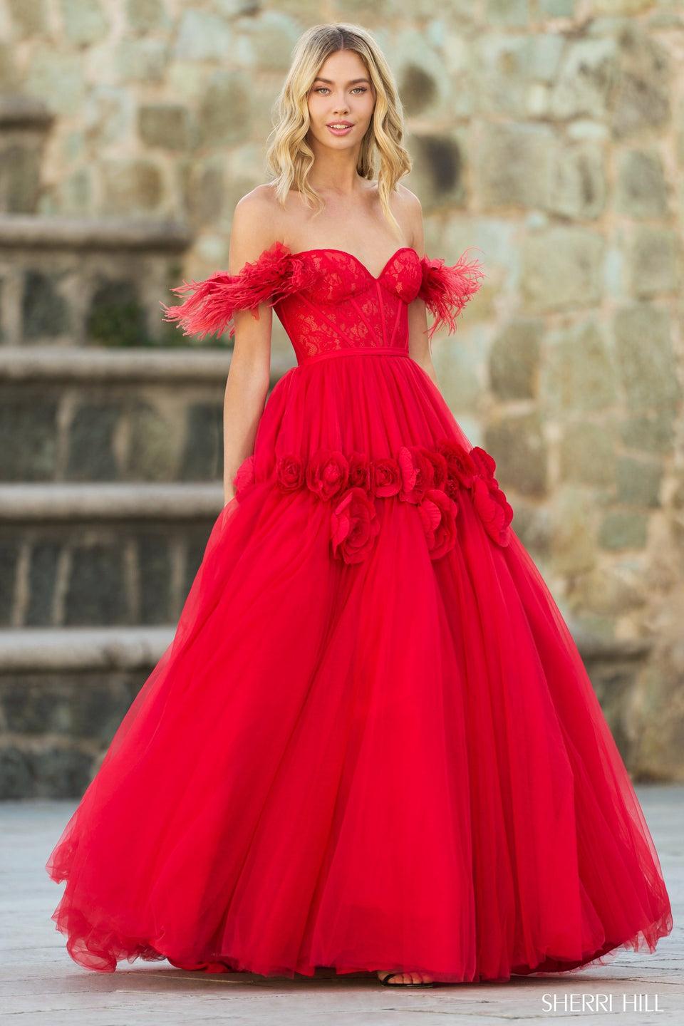 sherri hill Off the shoulder ball gown with a lace corset top feathered sleeves and tulle skirt with rose pedal embellishments