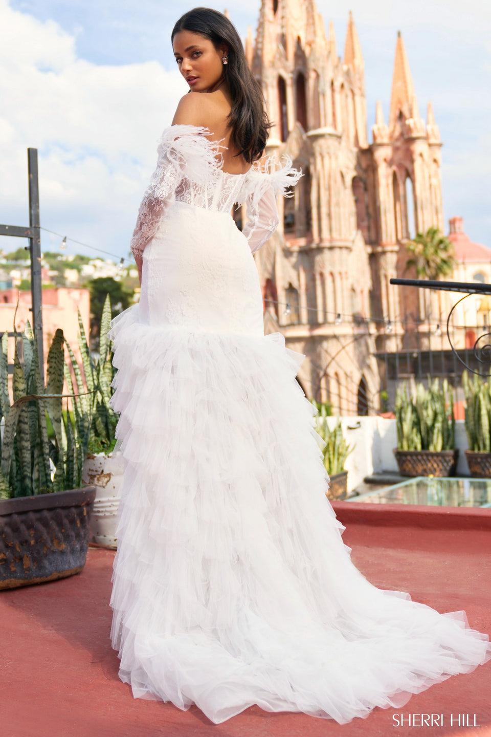 Sherri Hill One Shoulder Laced Mermaid Gown With A Sheer Corset Bodice Ruffled Skirt With High Slit And Detachable Sleeves With Feathers