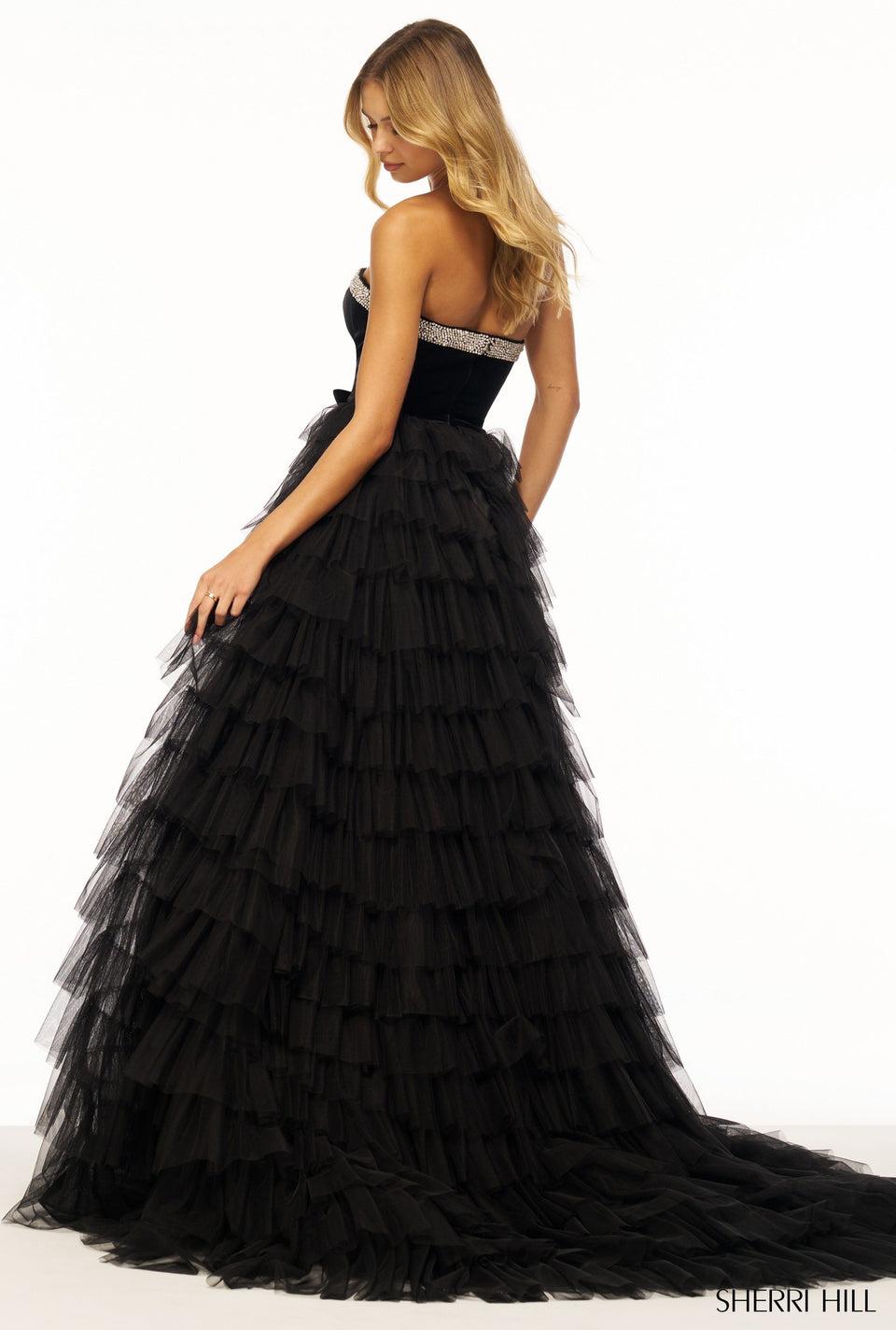 Sherri Hill Strapless Ballgown With A Ruffle Skirt And Slit And A Velvet Bodice Embellished With Bows Rhinestone Details And Cut-outs