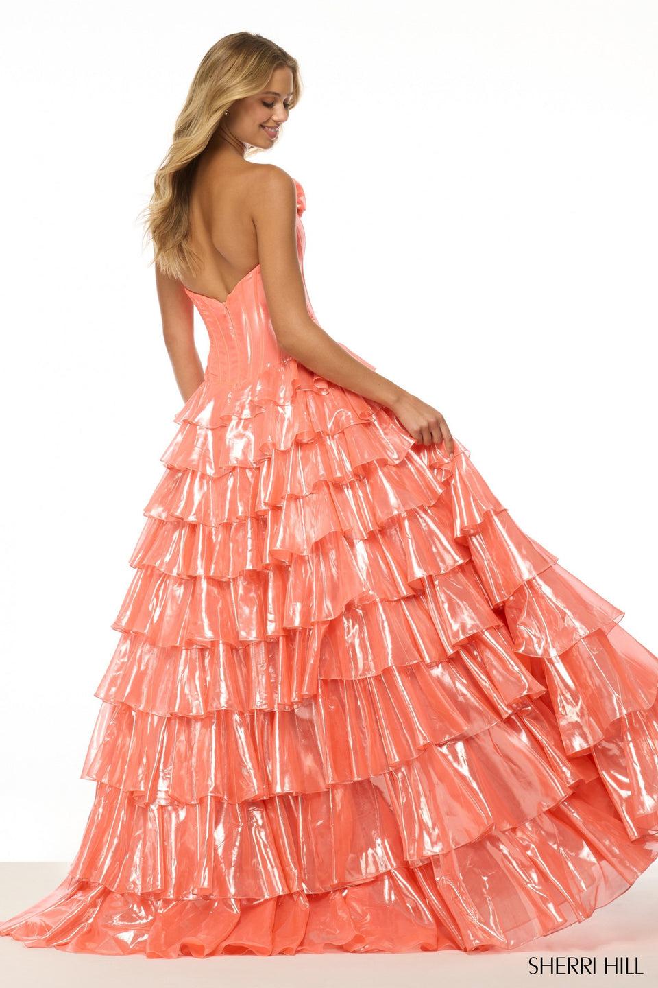 Sherri Hill Strapless Metallic Ballgown With Rosette Embellishments And A Ruffle Skirt With Slit