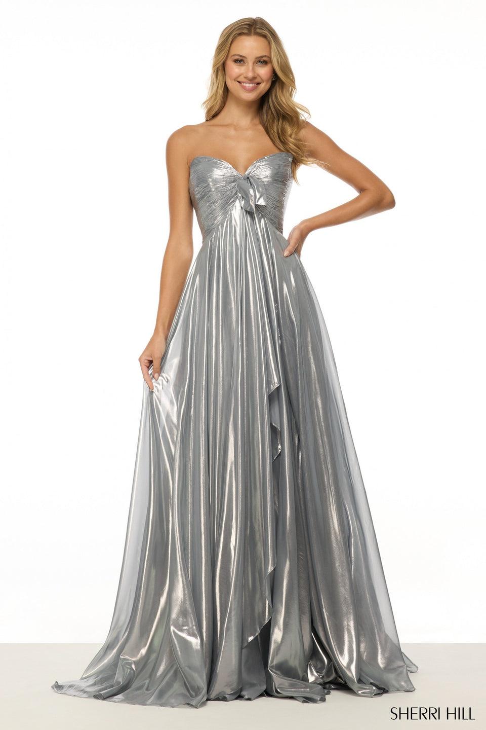 sherri hill Strapless metallic gown with skirt slit and a bow