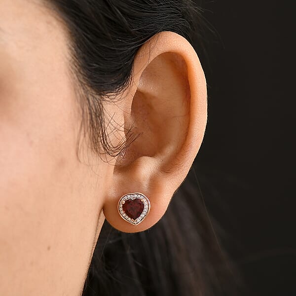Shop Lc D'Joy Mozambique Garnet And Moissanite 3.00 Ctw Heartfire Glow Earrings In 18K Vermeil Rose Gold Over Sterling Silver