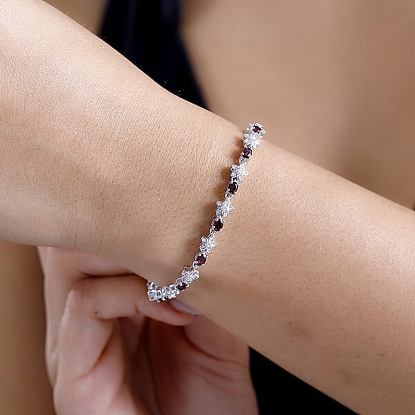 Shop Lc D'Joy Premium Anthill Garnet And Moissanite 6.00 Ctw Flower Bracelet In Rhodium Over Sterling Silver (8.00 In)