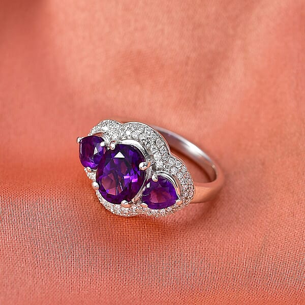 Shop Lc D'Joy Premium Lusaka Amethyst And Moissanite 3.00 Ctw Trilogy Ring In Rhodium Over Sterling Silver