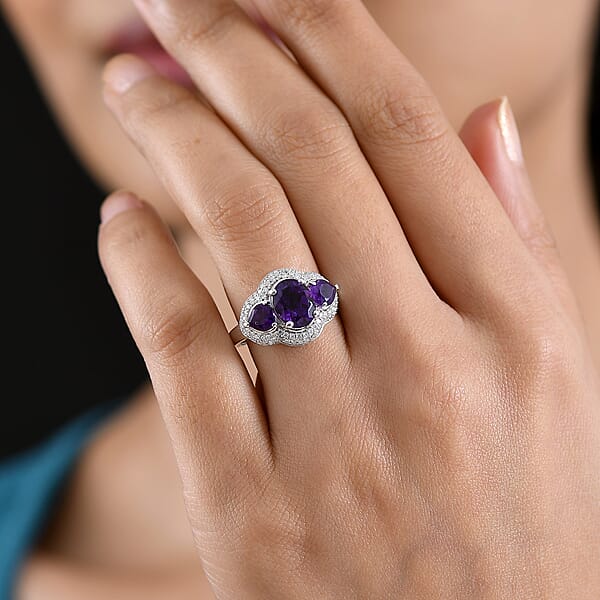Shop Lc D'Joy Premium Lusaka Amethyst And Moissanite 3.00 Ctw Trilogy Ring In Rhodium Over Sterling Silver