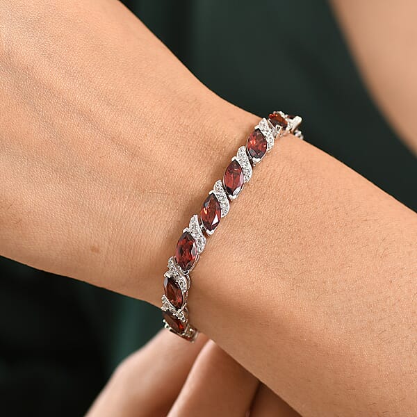 Shop Lc D'Joy Premium Mozambique Garnet And White Zircon 22.00 Ctw Passion Wave Bracelet In Rhodium Over Sterling Silver (7.25 In)