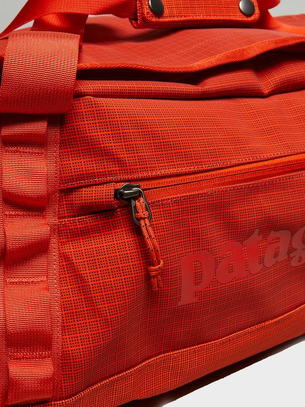 Stoy Black Hole Duffel 40L Bag In Pollinator Orange