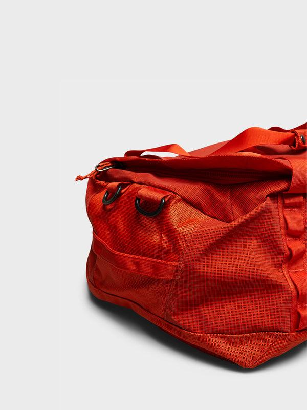 Stoy Black Hole Duffel 40L Bag In Pollinator Orange