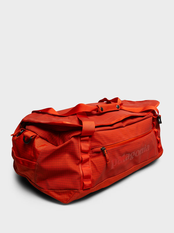 Stoy Black Hole Duffel 55L Bag In Pollinator Orange