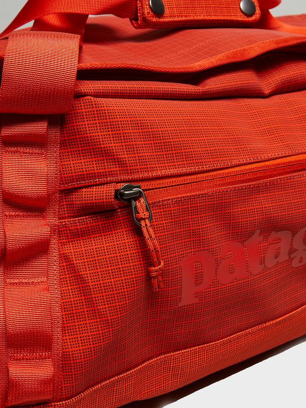 Stoy Black Hole Duffel 55L Bag In Pollinator Orange
