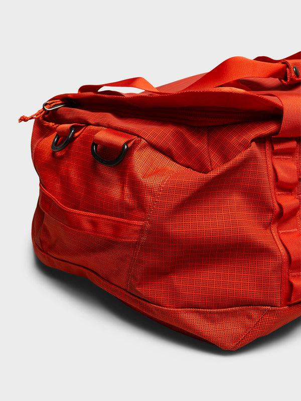 Stoy Black Hole Duffel 55L Bag In Pollinator Orange
