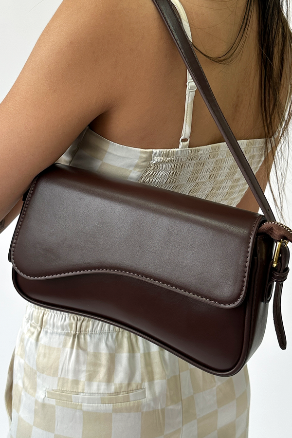 Svnx Curved Baguette Bag In Dark Brown