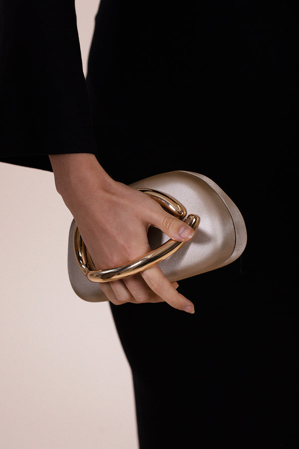 Svnx Oval Satin Hard Case Clutch Bag In Muted Gold