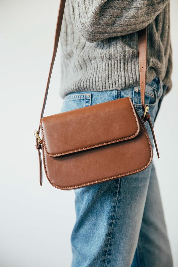 Svnx Rounded Cross Body Bag In Brown